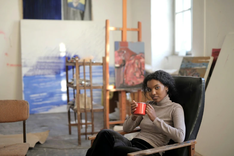 a woman sitting in a chair holding a cup, a portrait, pexels contest winner, arbeitsrat für kunst, young black woman, in an art gallery], portrait image, valentin serov style