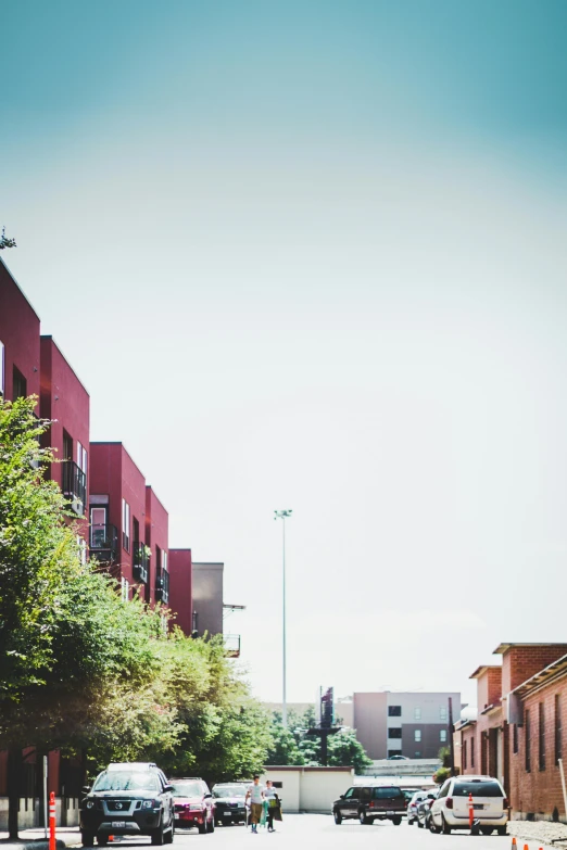 a red fire hydrant sitting on the side of a road, unsplash, photorealism, empty buildings with vegetation, tucson arizona, wide long view, apartments