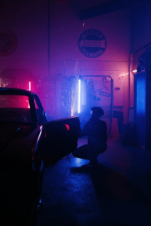 a man standing next to a car in a garage, cyberpunk art, inspired by Nan Goldin, pexels contest winner, conceptual art, neon colored haze, ( ( theatrical ) ), action scene, tail lights