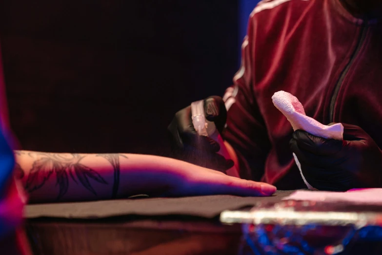 a man sitting at a table with a remote in his hand, a tattoo, pexels contest winner, process art, concert, white elbow gloves, magic effects, thumbnail