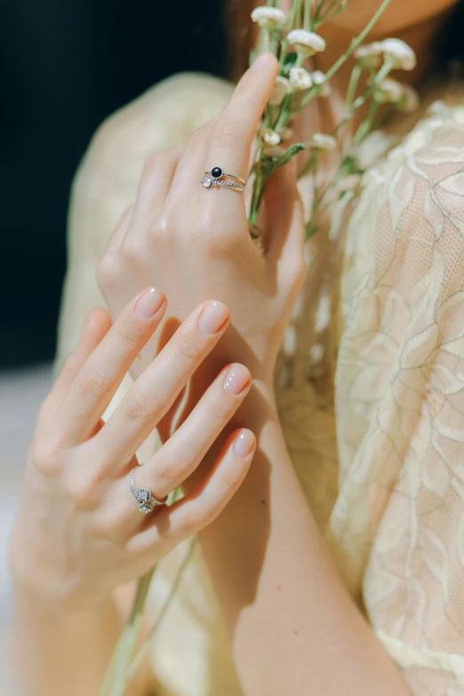 a close up of a person holding a flower, gold rings, thumbnail, 奈良美智, pearlescent skin