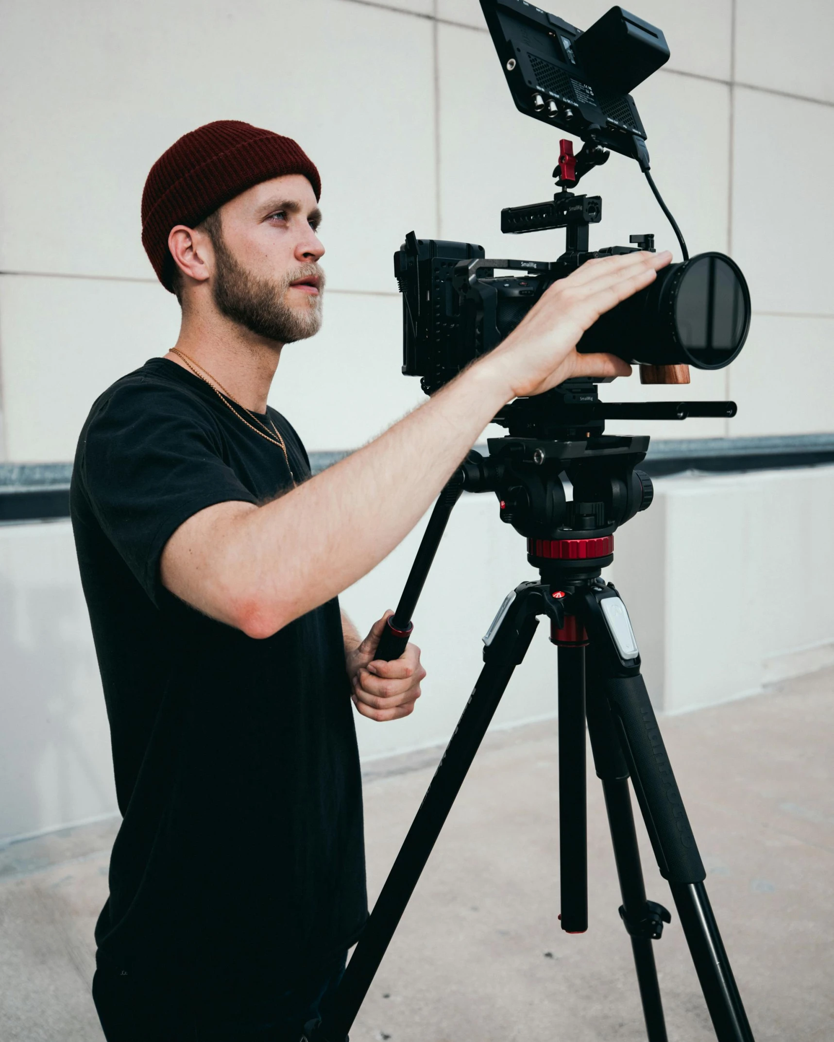 a man standing next to a camera on a tripod, by Adam Rex, pexels contest winner, video art, production quality cinema model, lgbtq, headshot, felix englund