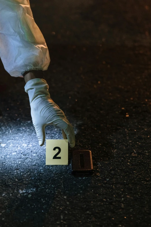 a person in white pants and white gloves on a street, an album cover, by Adam Marczyński, shutterstock, crime scene photo, photograph credit: ap, gunfire, 2022 photograph