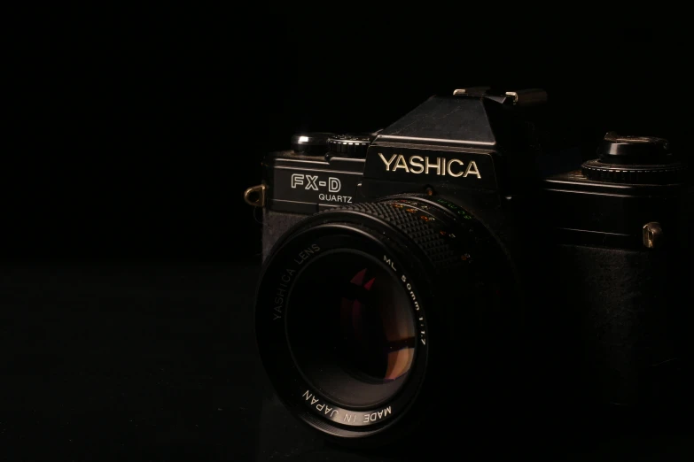 a black camera sitting on top of a table, a picture, inspired by Takahashi Yuichi, unsplash, hyperrealism, 1 9 8 0 s tech, sigma 85/1.2 portrait, with a black background, vhsrip