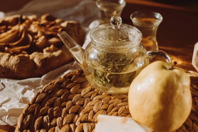 a tea pot sitting on top of a wooden table, a still life, trending on pexels, fruits in a basket, thumbnail, inside a glass jar, crisp details