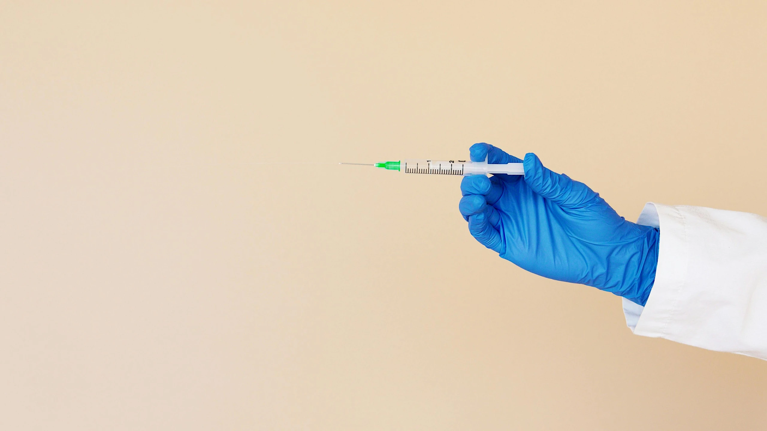 a person in a white lab coat holding a syet, by Gavin Hamilton, shutterstock, plasticien, iv pole, instagram post, wearing gloves, holding syringe