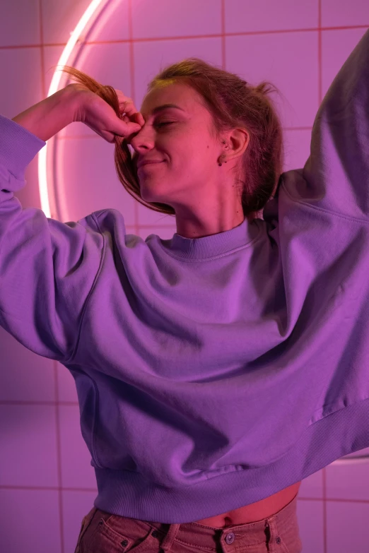 a woman that is standing in front of a mirror, a colorized photo, inspired by Elsa Bleda, trending on pexels, happening, wearing a purple sweatsuit, happy trippy mood, soft lighting from above, purple lights