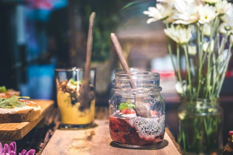 a jar of food sitting on top of a wooden table, trending on unsplash, breakfast buffet, 🦩🪐🐞👩🏻🦳, sea of parfait, avatar image