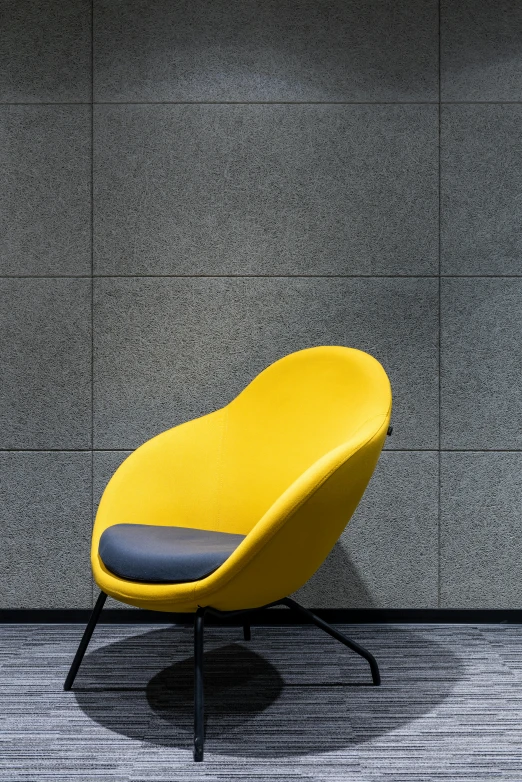 a yellow chair sitting in front of a gray wall, yellow carpeted, panels, thumbnail, acoustic information