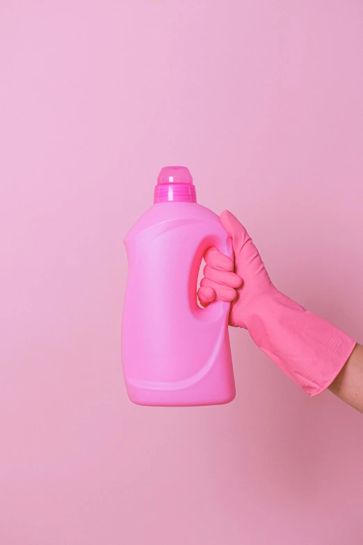 a person in pink gloves holding a pink spray bottle, backdrop, less detailing, ((pink)), pristine clean design