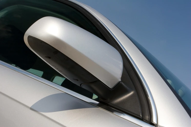 the side view mirror of a silver car, by Julian Allen, aerodynamic body, striking features, opaque visor, thumbnail