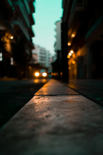 a sidewalk in the middle of a city at night, by Niko Henrichon, close-up photograph, high quality image, city morning, medium long shot