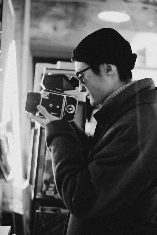 a black and white photo of a man holding a camera, peter chung + moebius + loish, brandon woelfel, profile pic, lofi aesthetic