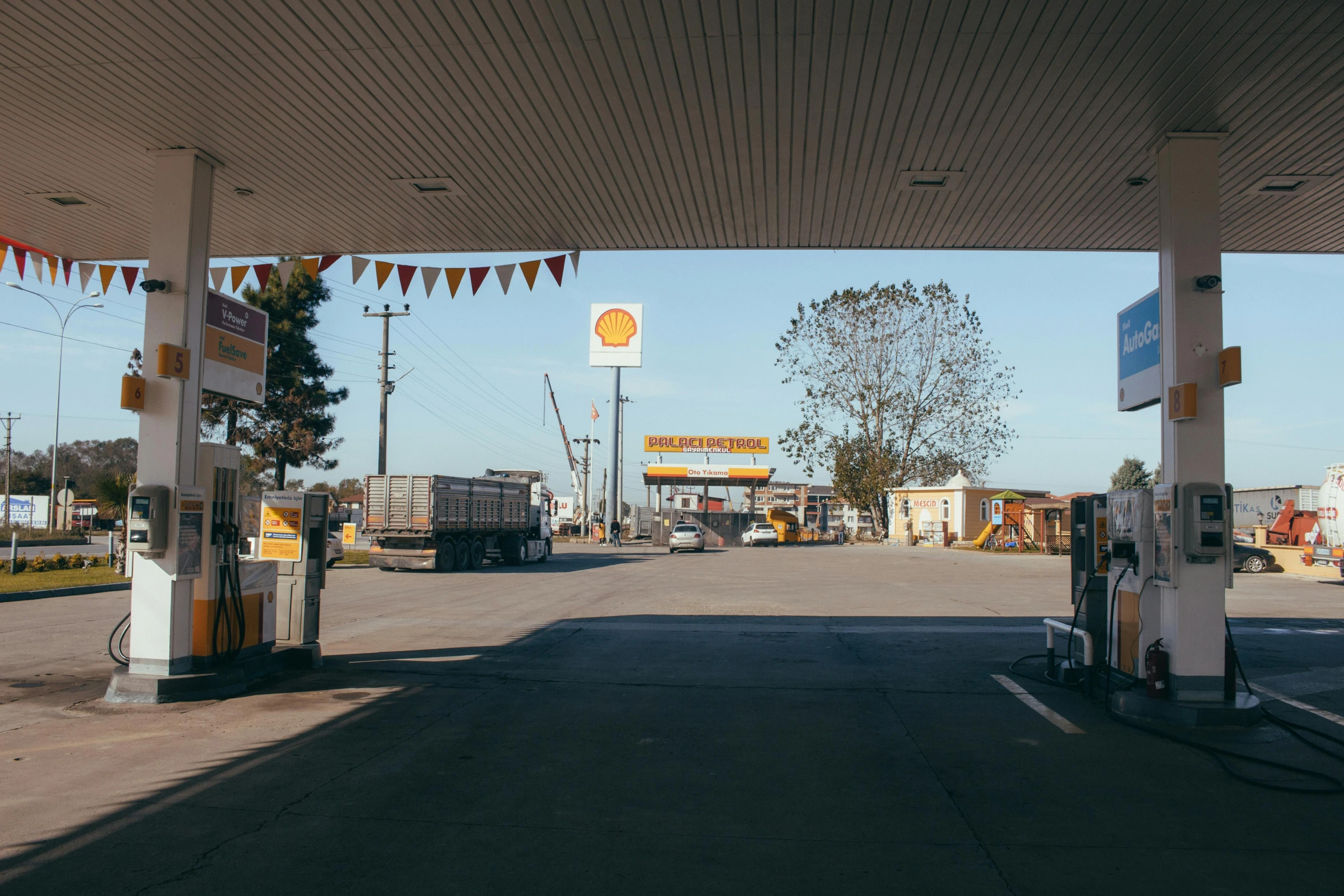 a gas station filled with lots of gas, a portrait, unsplash, on a hot australian day, white and yellow scheme, brown, suns