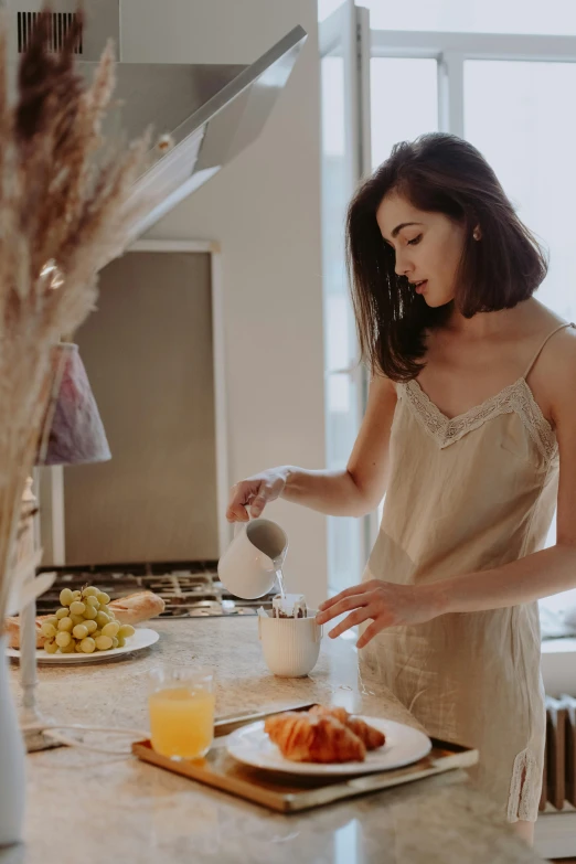 a woman standing in a kitchen preparing food, pexels contest winner, renaissance, milk and mocha style, young asian woman, hearty breakfast, profile image