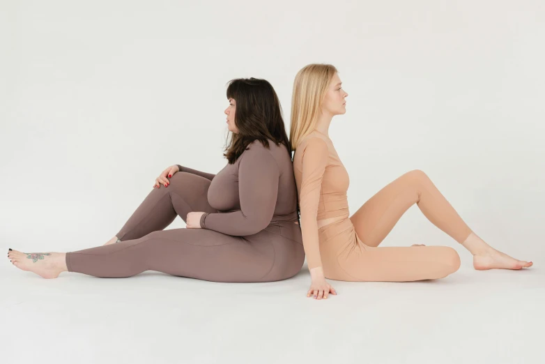 a couple of women sitting next to each other, inspired by Sarah Lucas, trending on pexels, in spandex suit, taupe, overweight, full product shot