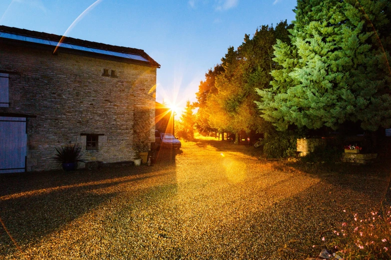 the sun is setting behind a stone building, renaissance, delightful surroundings, autumn lights, slide show, conde nast traveler photo