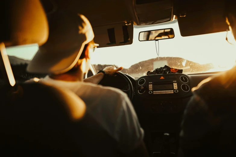 a couple of people that are sitting in a car, by Carey Morris, pexels, square, high quality image, late afternoon, cockpit view