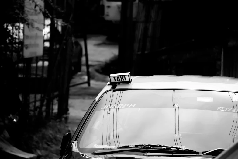 a black and white photo of a taxi cab, by Tamas Galambos, unsplash, bangkok, square, low detailed, neighborhood