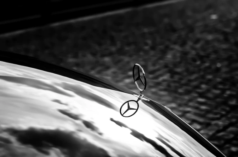 a mercedes emblem on the hood of a car, a black and white photo, by Matthias Weischer, precisionism, chromed metal, celebration, curves!!, peace