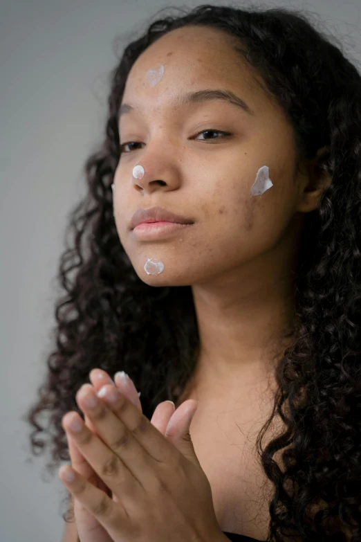 a woman with a lot of cream on her face, by Juan O'Gorman, pexels, renaissance, teenage girl, sza, holding it out to the camera, with detailed