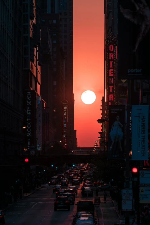 a street filled with lots of traffic next to tall buildings, by Adam Rex, unsplash contest winner, renaissance, red sun over paradise, chicago, ((sunset)), giant sun