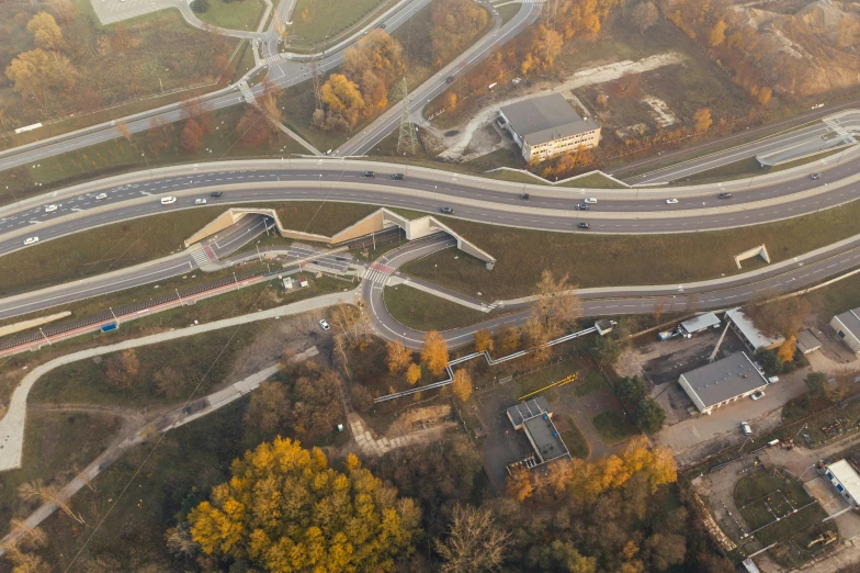 an aerial view of a highway intersection in the fall, by Jacob Toorenvliet, van lieven, curved bridge, school, wim crouwel