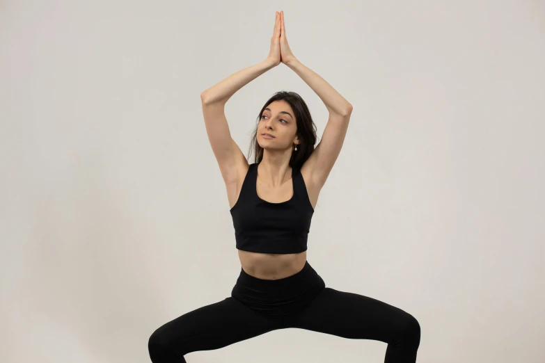a woman doing a yoga pose against a white background, pexels contest winner, black spandex, middle eastern, upper body avatar, : :