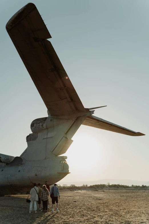 a group of people standing in front of an airplane, upclose, afternoon sun, gunship, close-up photograph