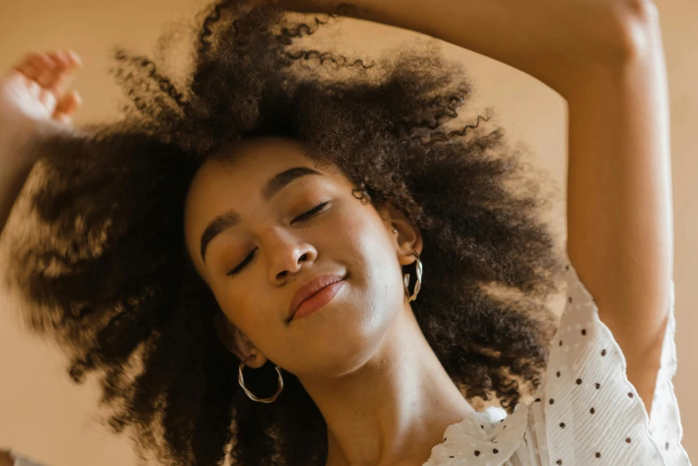 a close up of a woman with her hair in the air, trending on pexels, happening, ashteroth, relaxed pose, waking up, 3 / 4 pose