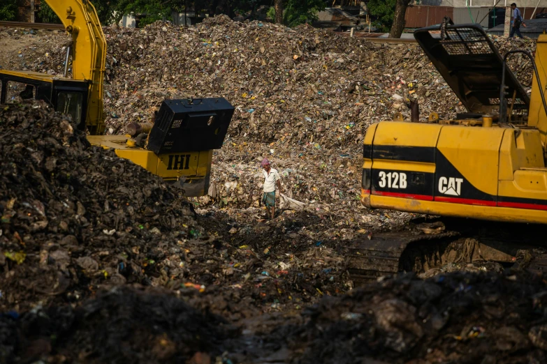 a couple of machines sitting on top of a pile of trash, avatar image, documentary photo, people at work, 2 0 2 2 photo