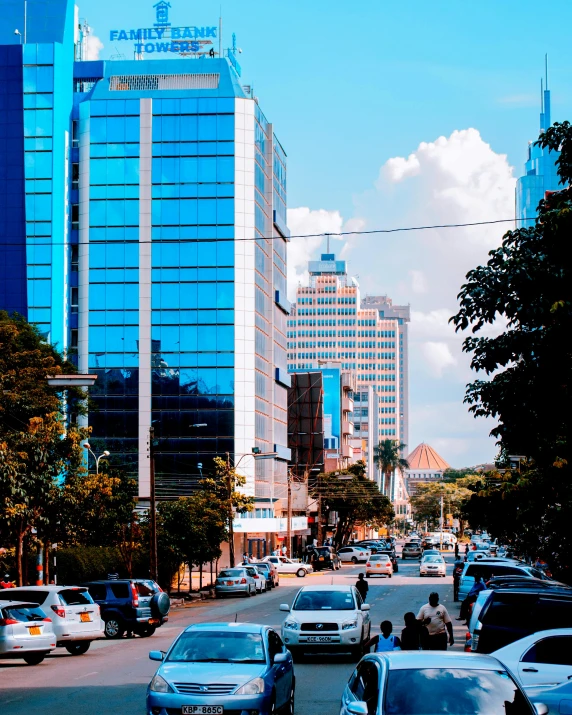 a city street filled with lots of traffic and tall buildings, by Ingrida Kadaka, blue and clear sky, very kenyan, background image, beautiful photo