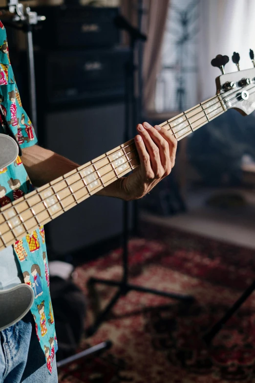 a man playing a bass guitar in a music studio, pexels contest winner, photorealism, gnarled fingers, multicoloured, casually dressed, extra high resolution