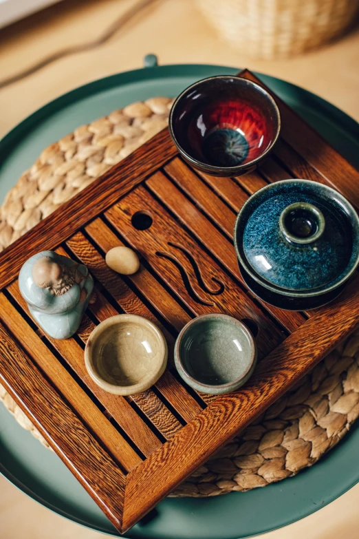 a wooden tray sitting on top of a table, inspired by Ma Lin, trending on unsplash, mingei, square, blue, tea, various colors