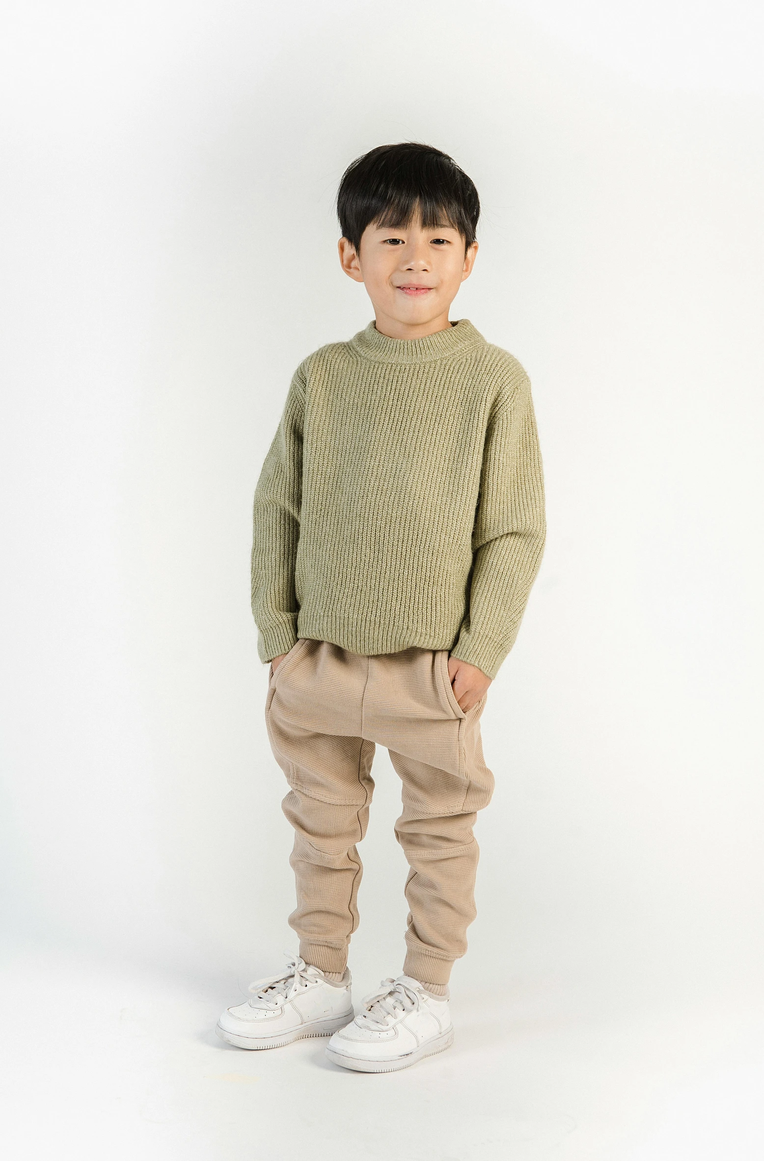 a young boy in a green sweater and khaki pants, wearing an oversized sweater, japanese collection product, thumbnail, full height