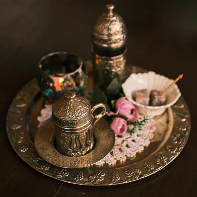 a silver tray sitting on top of a wooden table, dau-al-set, magical items, coffee, bronze, high quality product image”