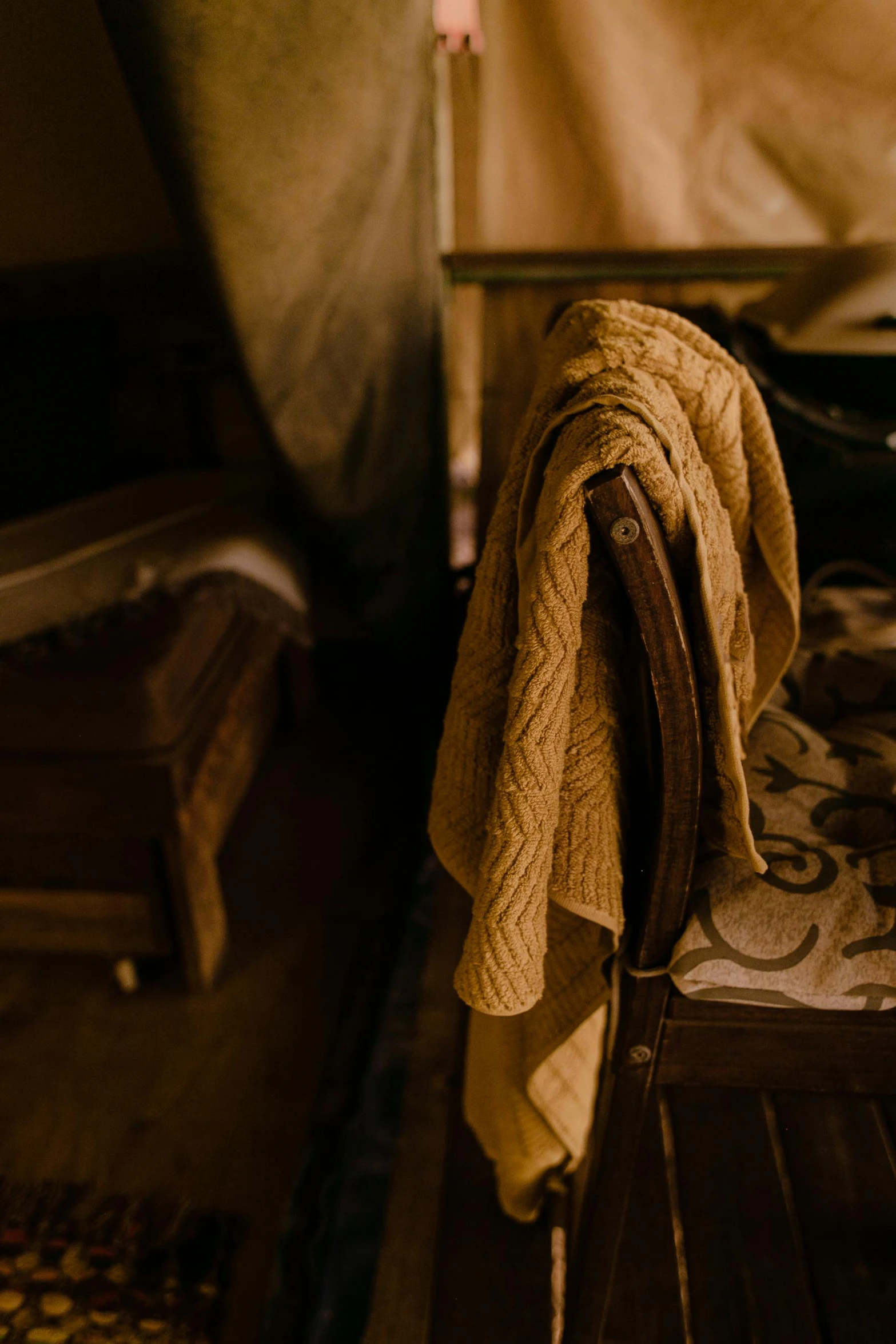 a bed with a blanket on top of it, a portrait, unsplash, renaissance, old chairs, atmospheric warm colorgrade, brown, cottagecore