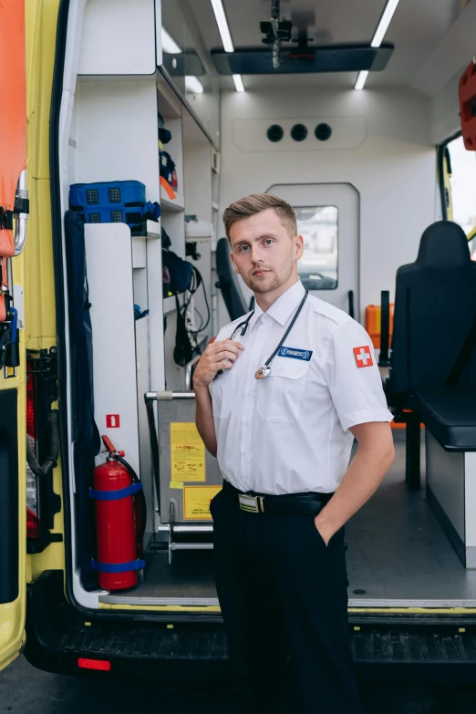 a man standing in the back of an ambulance, by Adam Marczyński, full uniform, square, mechanic, official