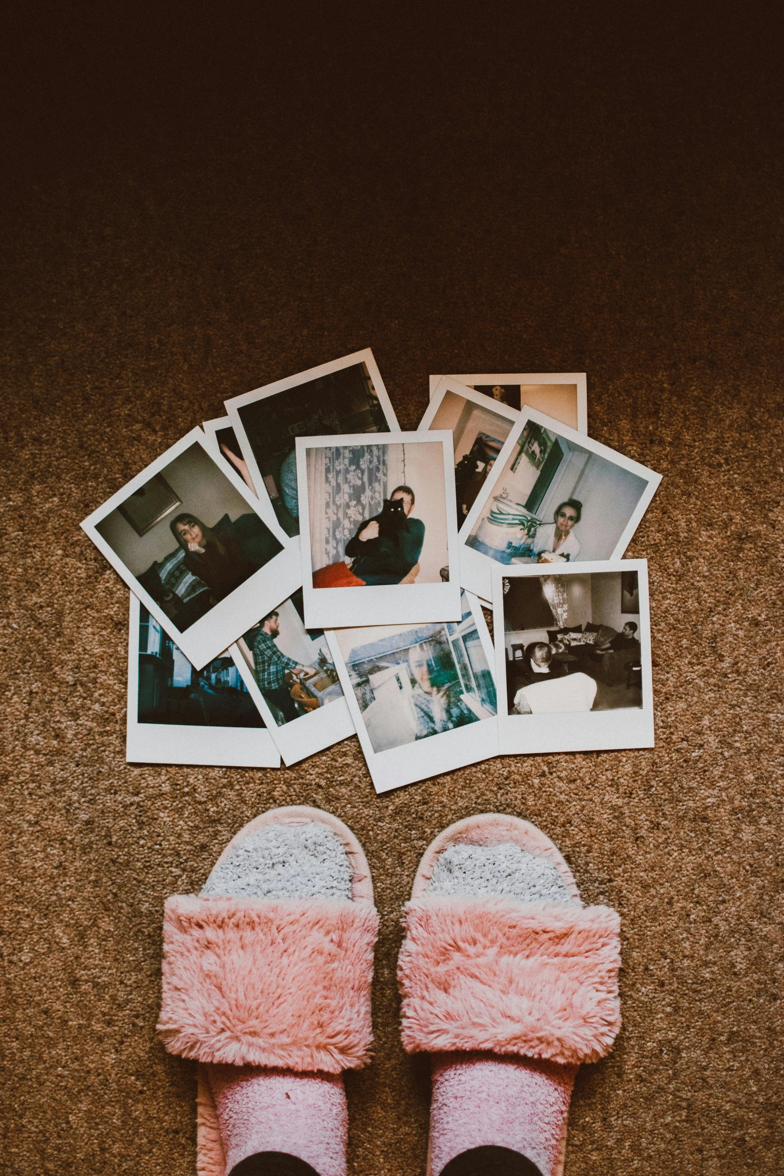 a pair of pink slippers sitting on top of a carpet, a polaroid photo, inspired by Elsa Bleda, trending on pexels, pictures of family on wall, vhs effects, polaroid photo with flash, many pieces