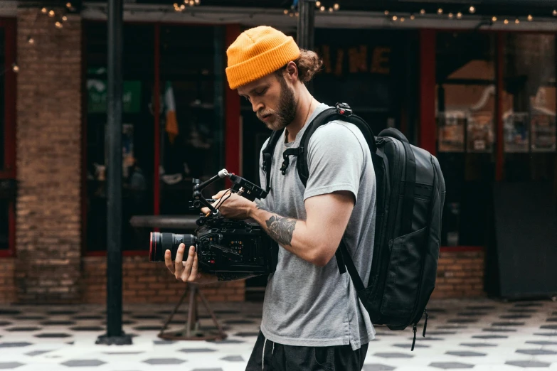 a man with a camera and a backpack, happening, style of seb mckinnon, 4k press image, trending on r/techwearclothing, full scene shot