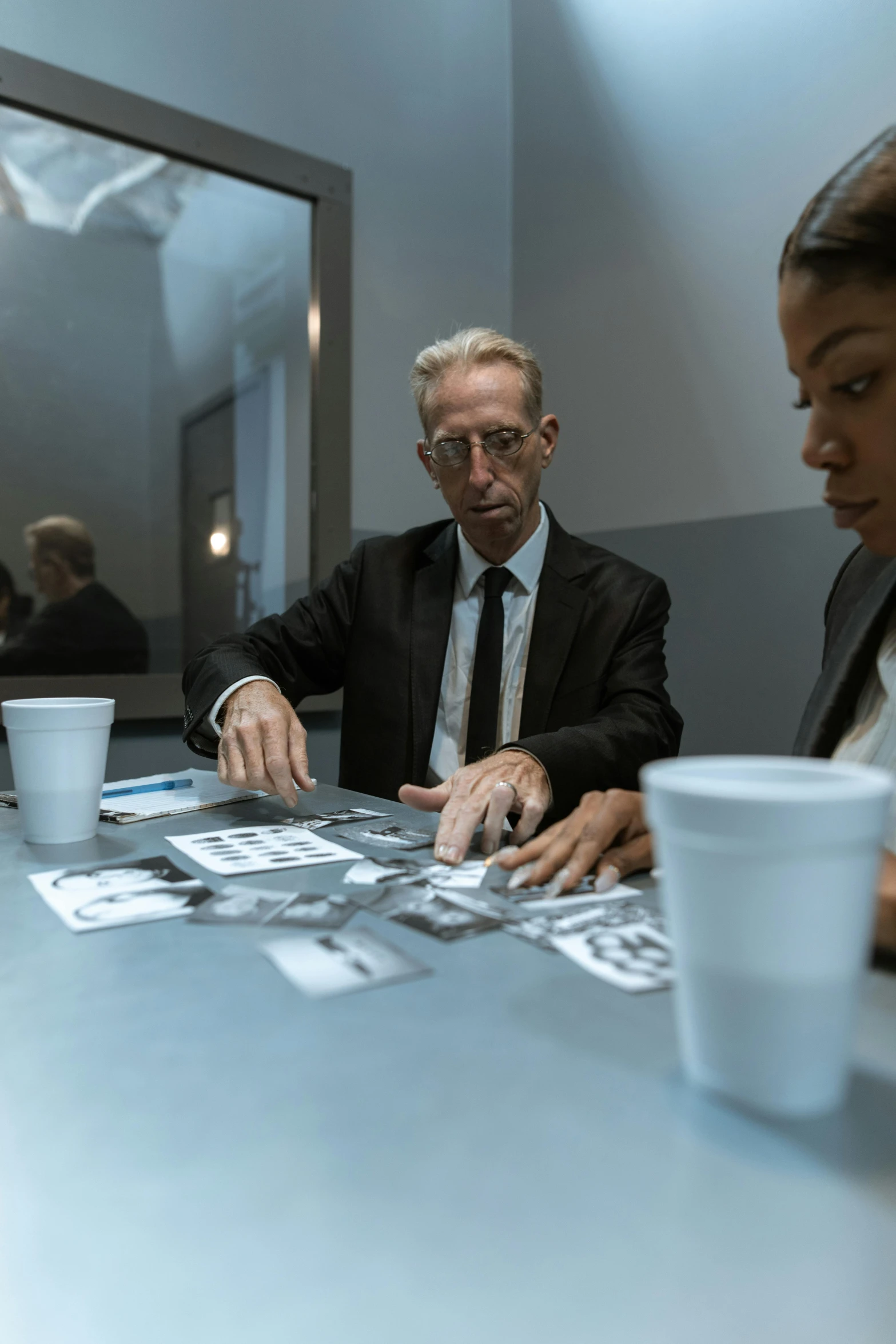 a group of people sitting around a table, inspired by Richard Hamilton, unsplash, hyperrealism, u.s. national security advisor, two men in black, david cronenberg, in a research facility