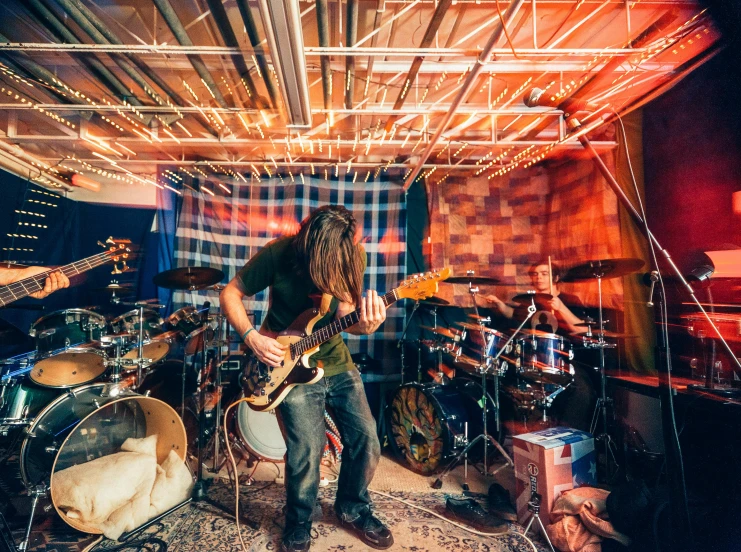 a group of people playing instruments in a room, by Matt Cavotta, unsplash, stoner rock, a crystalline room, in his basement studio, evenly lit