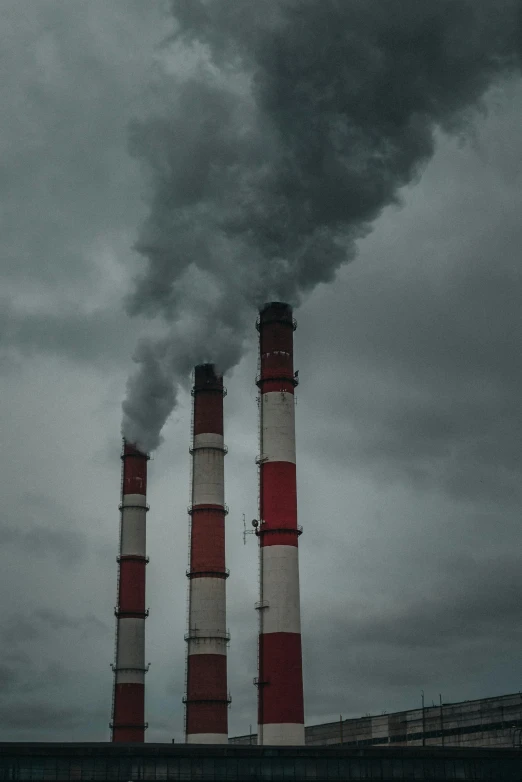 a factory with a lot of smoke coming out of it, pexels, three towers, paul barson, a pair of ribbed, n- 9