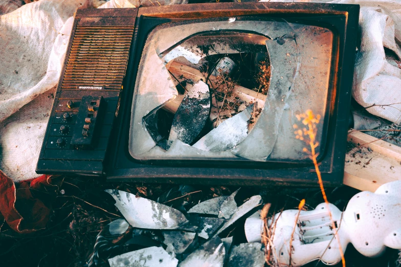 an old television sitting on top of a pile of broken glass, inspired by Elsa Bleda, unsplash, 🦩🪐🐞👩🏻🦳, mining scrap metal, facebook post, ad image