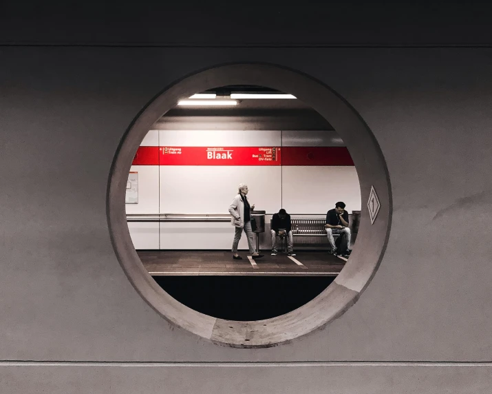 a group of people waiting at a train station, a photo, pexels contest winner, postminimalism, round window, gray concrete, underground tunnel, eka's portal