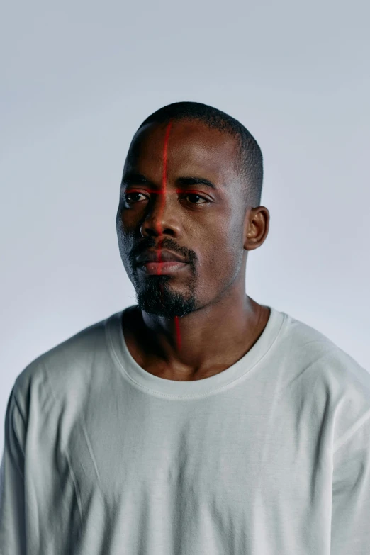 a man standing in front of a white background, an album cover, inspired by Theo Constanté, short goatee, red eyes and a slim face, hyperrealism photo, portrait photo of a backdrop