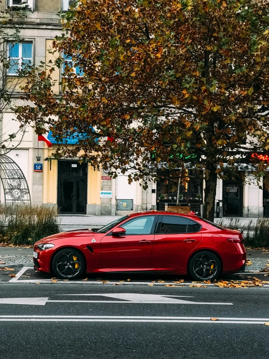 a red sports car parked on the side of the road, by Julia Pishtar, pexels contest winner, renaissance, 🎀 🗡 🍓 🧚, in the autumn, square, alfa romeo giulia