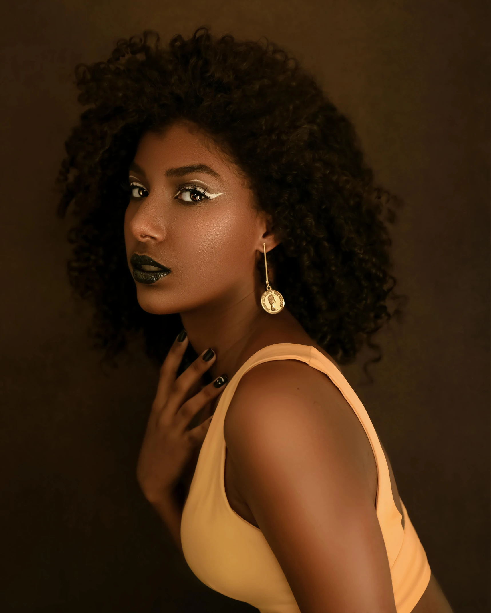 a woman in a yellow top posing for a picture, by Lily Delissa Joseph, trending on pexels, afrofuturism, girl with a pearl earringl, dark brown skin, curly blonde hair | d & d, iridescent skin