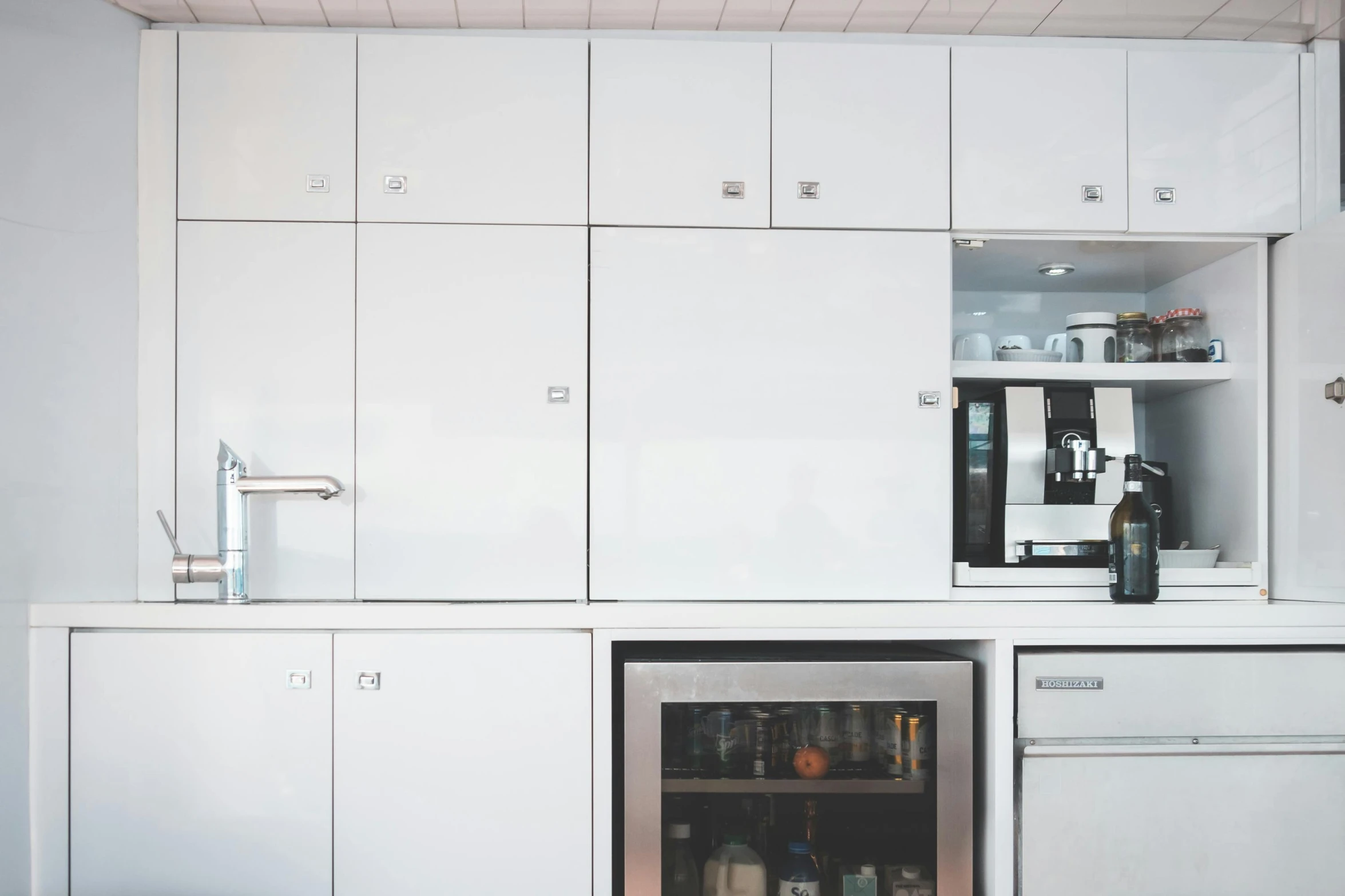 a kitchen with white cabinets and stainless steel appliances, inspired by Dennis Miller Bunker, unsplash, modernism, close-up photograph, dwell, drink, modular