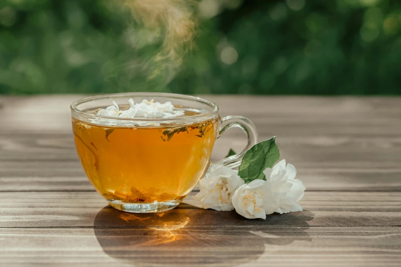 a cup of tea sitting on top of a wooden table, jasmine, botanicals, thumbnail, sparkling